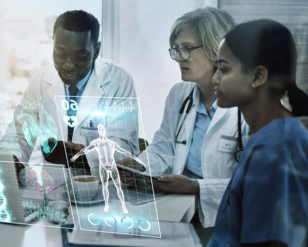 Team of doctors in front of a laptop with graphic overlay