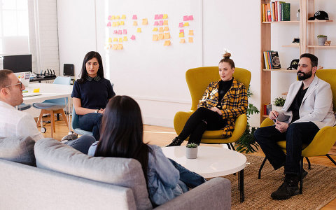 PR brainstorm meeting - people sitting in a room, discussing something