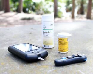 Digital measurement devices lying next to vials of pills