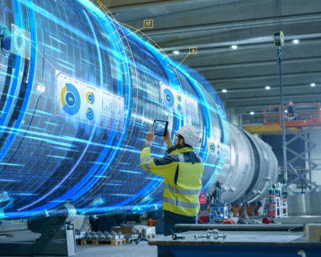 High-complexity AI services Engineer standing in front of large machine with digital overlay