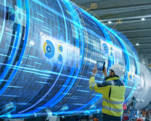 An ongoing inbound marketing programme Engineer standing in front of large machine with digital overlay
