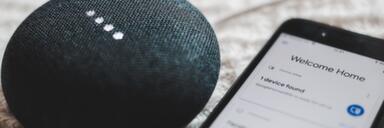 The Internet of Things Bluetooth speaker lying next to phone