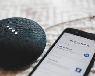 The Internet of Things Bluetooth speaker lying next to phone