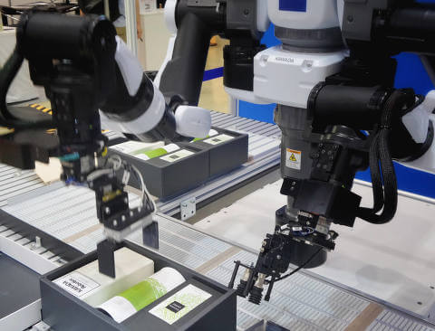 Robotic arms handling products on the factory line