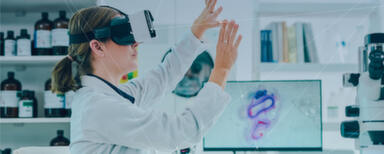 A scientist wearing VR goggles, sitting at a desk in a laboratory