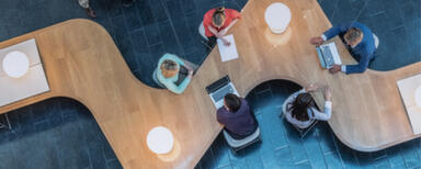 Birdseye view of people working in an open-plan office